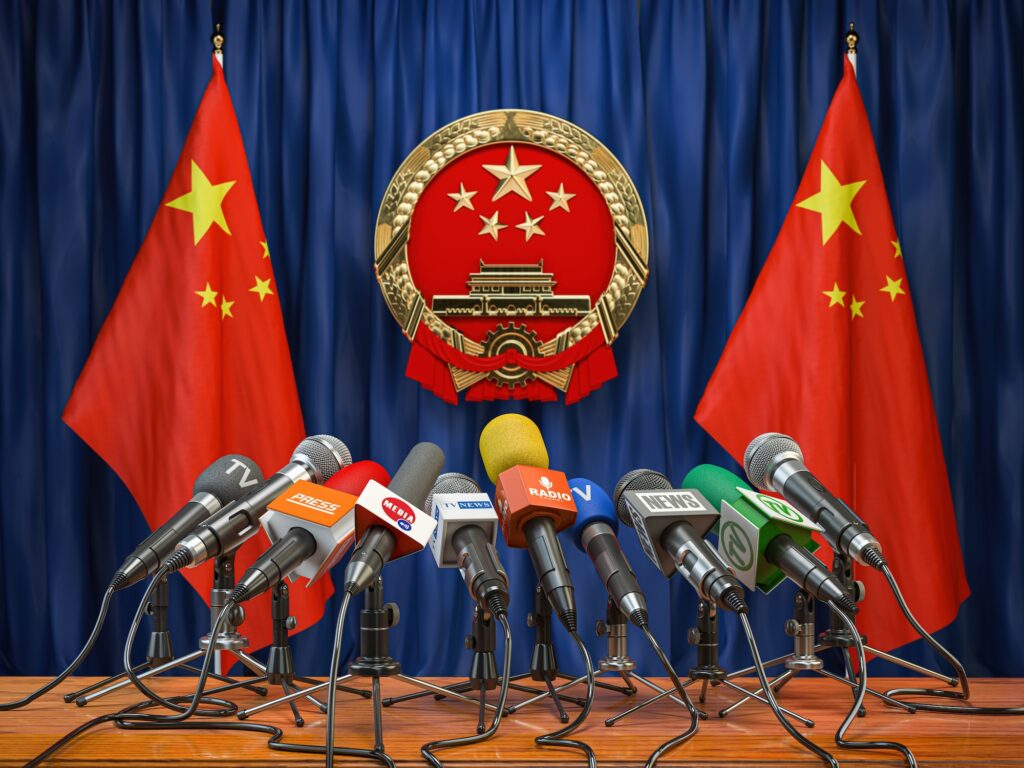 Official press conference of China fgoverment or president. Flags of China and microphones.